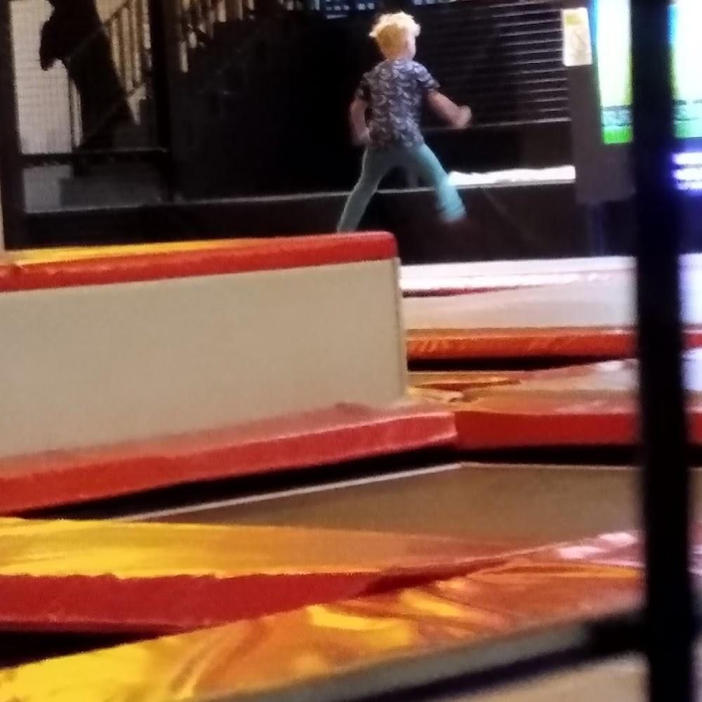 A boy jumping on a trampoline.